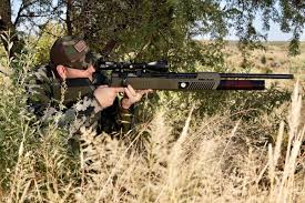 Pest control operator in prone shooting position